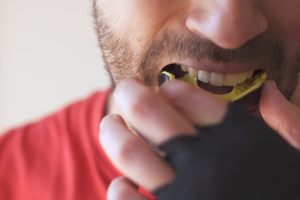 Patient in Austin wearing a mouthguard with dental implants