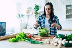 Woman preparing healthy salad at home