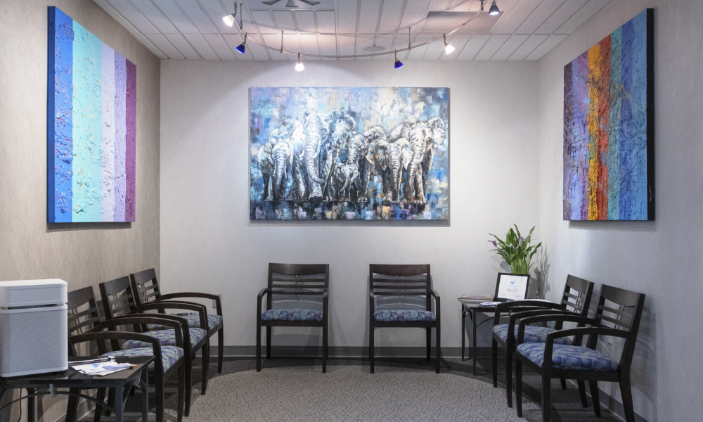 Dental team member smiling behind reception desk